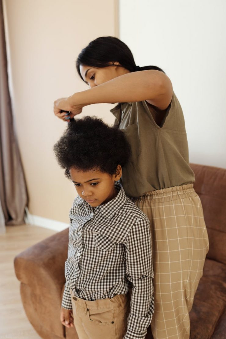 mother helping her son to get changed