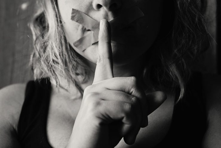 woman placing her finger between her lips